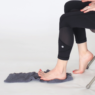 Una donna seduta stroppiccia un asciugamano con il piede